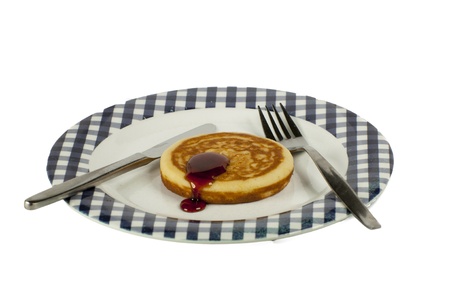 single pancake on a plate isolated on a white backgroundの写真素材