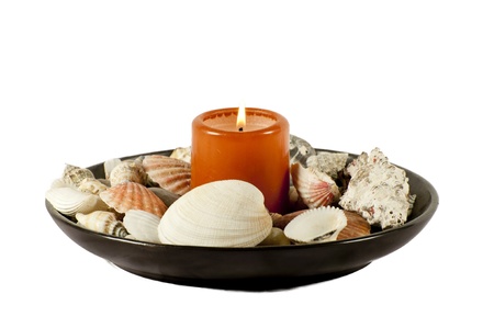 burning candle with shells isolated on a white backgroundの写真素材