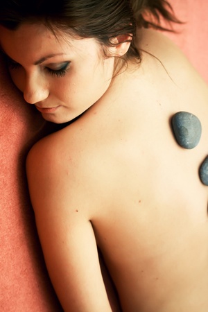 A portrait of a girl on the towel in a spa. She looks relaxed and calm.の写真素材