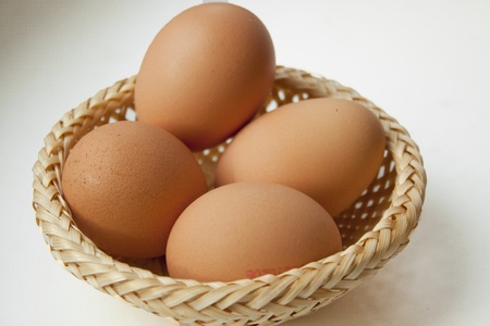 Basket with several eggs is standing on the table.の写真素材