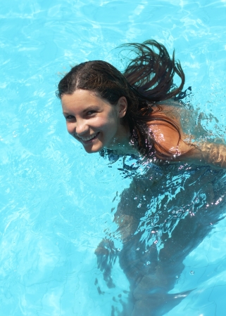 Smiling young woman in the swimming poolの写真素材