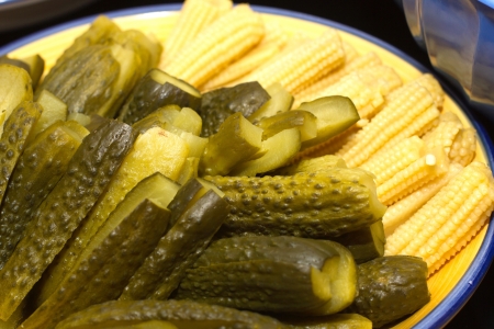 Image of pickles and corn on the plate の写真素材