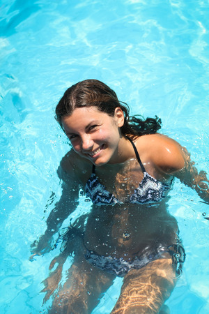 Picture of a smiling young woman in the swimming poolの写真素材