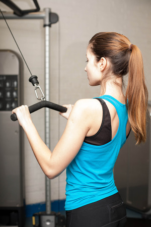 Photo of a girl working out in the gym.