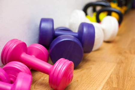 Picture of colorful dumbbells on the floor in the gymの写真素材