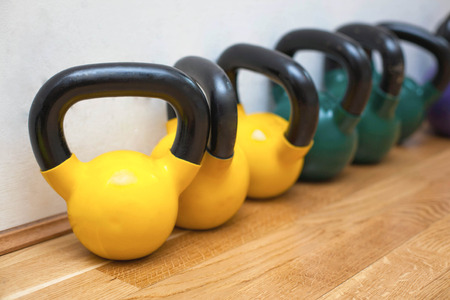 Colorful kettle bells on the floor in the gymの写真素材