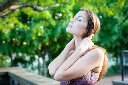 Girl enjoying the sunshine in the parkの写真素材