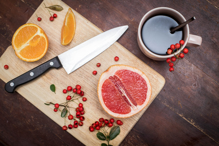 Coffee and fruits on the cutting boardの写真素材