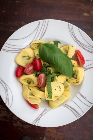 Ravioli with tomatos and basil on the tableの写真素材
