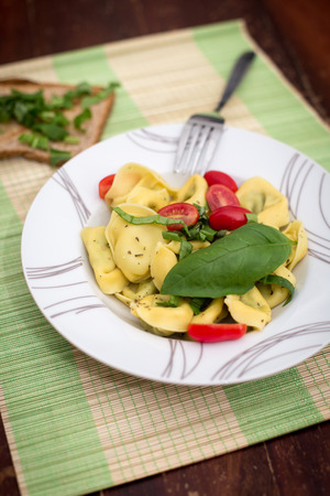 Ravioli with tomatos and basil on the tableの写真素材
