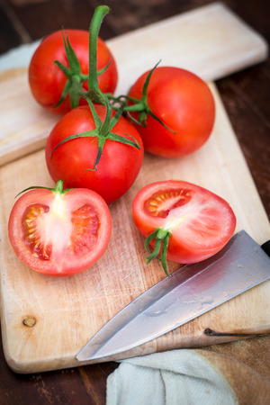 Fresh ripe tomatoes on the chopping boardの写真素材