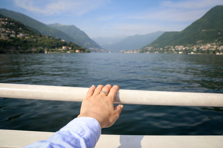 Boat tour landscape on the background hand on the foregroundの写真素材