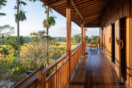 Chair on the balcony in a wooden house with a beautiful viewの写真素材