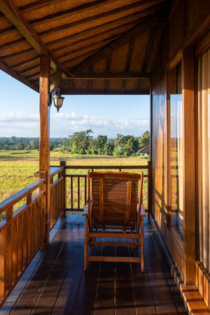 Chair on the balcony in a wooden house with a beautiful viewの写真素材