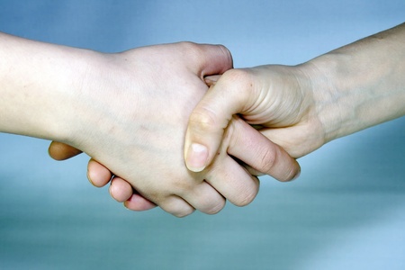Handshake-two hands holding on.