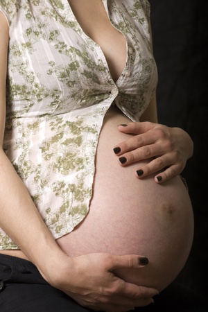Close up of the pregnant woman holding her belly.の写真素材