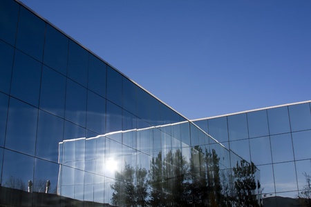 Detail of the exterior of the glass office building.