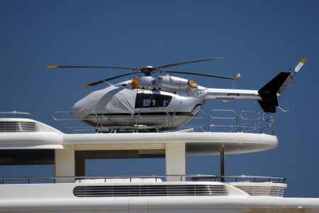 Silver helicopter on the deck of the yacht.の写真素材