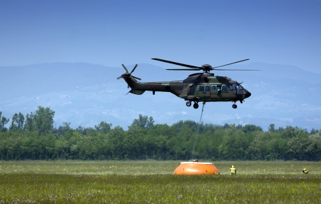 Helicopter floating and picking up water.の写真素材