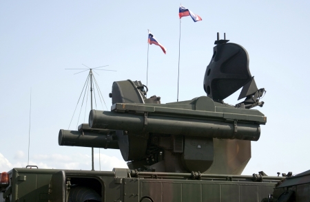 Detail of the military anti-aircraft rocket system with two small Slovenian flags on it.