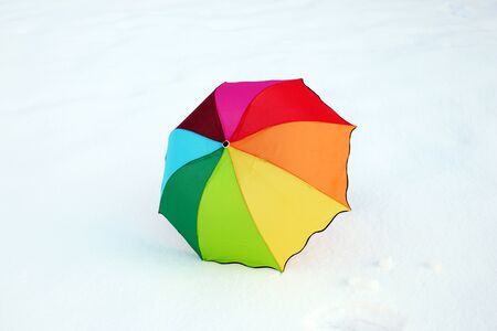 Rainbow colorful umbrella in the fresh snow.の写真素材