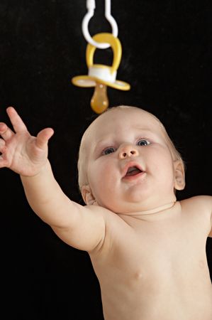little baby trying to grasp the dummyの写真素材