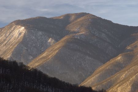 snow mountain peaks and sunset light. Red Field, Sochi, Russia.