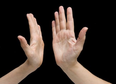 two applauding hands isolated on black