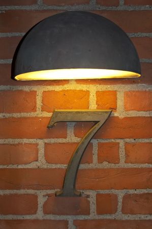 alight number seven on red brick wallの写真素材