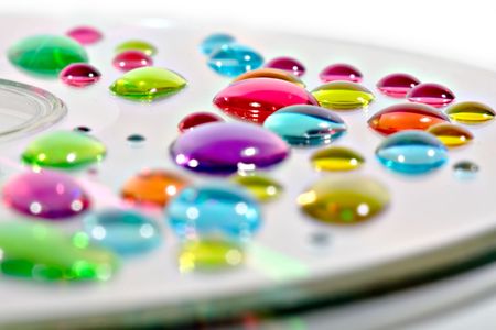 Several color drops on a CD's surfaceの写真素材