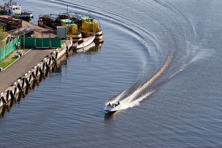 high speed motor boat with wave trail on the waterの写真素材