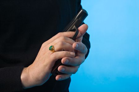 black and white close-up shot of man's hands with pistolの写真素材
