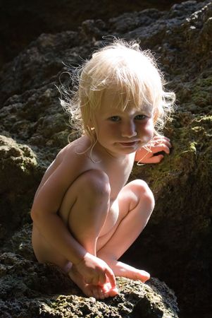 fine-art portrait of beautiful blonde little girl on nature backgroundの写真素材