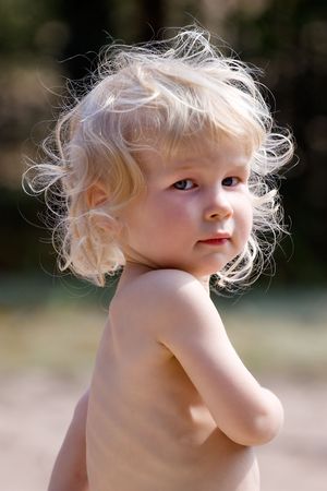 fine-art portrait of beautiful blonde little girl on nature backgroundの写真素材