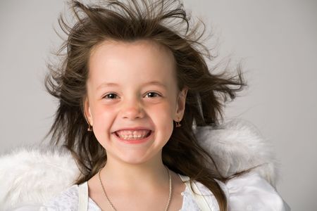 happy little girl in white dress and angel wingsの写真素材