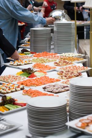 table with a lot of food for stand-up meal in a buffet