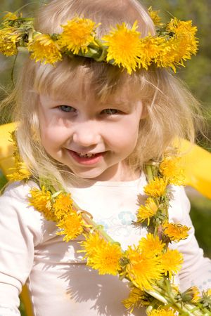 little girl in flower wreath close-up portraitの写真素材