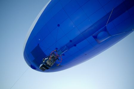flying blimp close-up on clear blue sky backgroundの写真素材