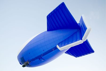 flying blimp on clear blue sky backgroundの写真素材