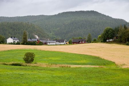 Beautiful rural landscape, small houses near mountainsの写真素材