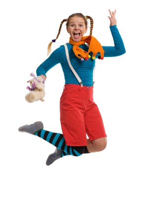 cheerful girl in multi-coloured clothes jumps isolated on whiteの写真素材