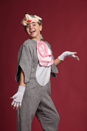 beautiful smiling girl in mouse costume on red backgroundの写真素材