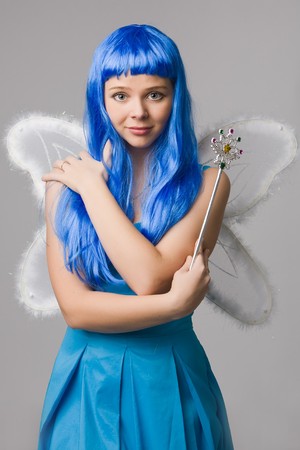 Beautiful girl with  blue hair and  in blue dress with open-air look fold one's handの写真素材