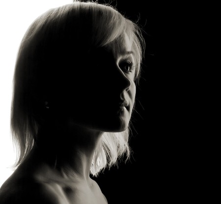 young woman fine-art high-contrast portrait in backlightの写真素材