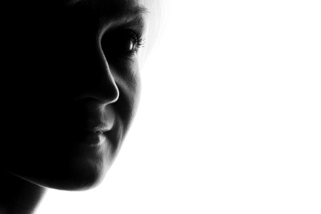 young woman fine-art high-contrast portrait in backlightの写真素材