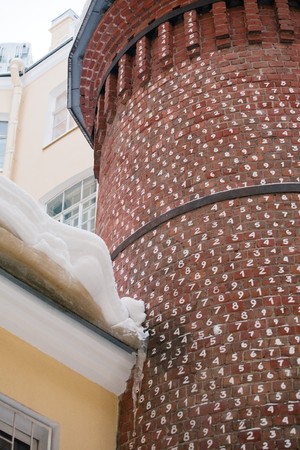 red tower with white number on every brick, mysterious building in Saint-Petersburg, Russiaの写真素材