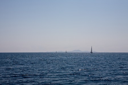seascape with three yacht on the horizonの写真素材