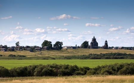 summer landscape with old beautiful Russian village with wooden churchの写真素材