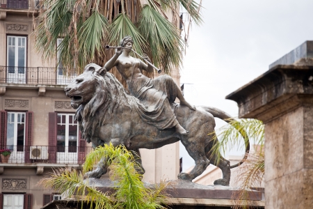Statue of lyric opera (woman on a lion) standing before Teatro Massimo, Palermo, Italyの写真素材