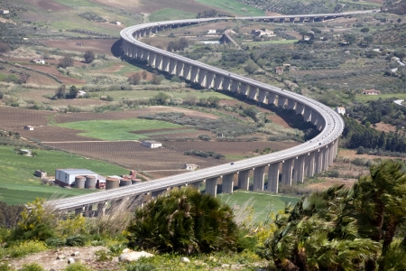 new modern highway winding among green valley, Segesta village, Sicily, Italy